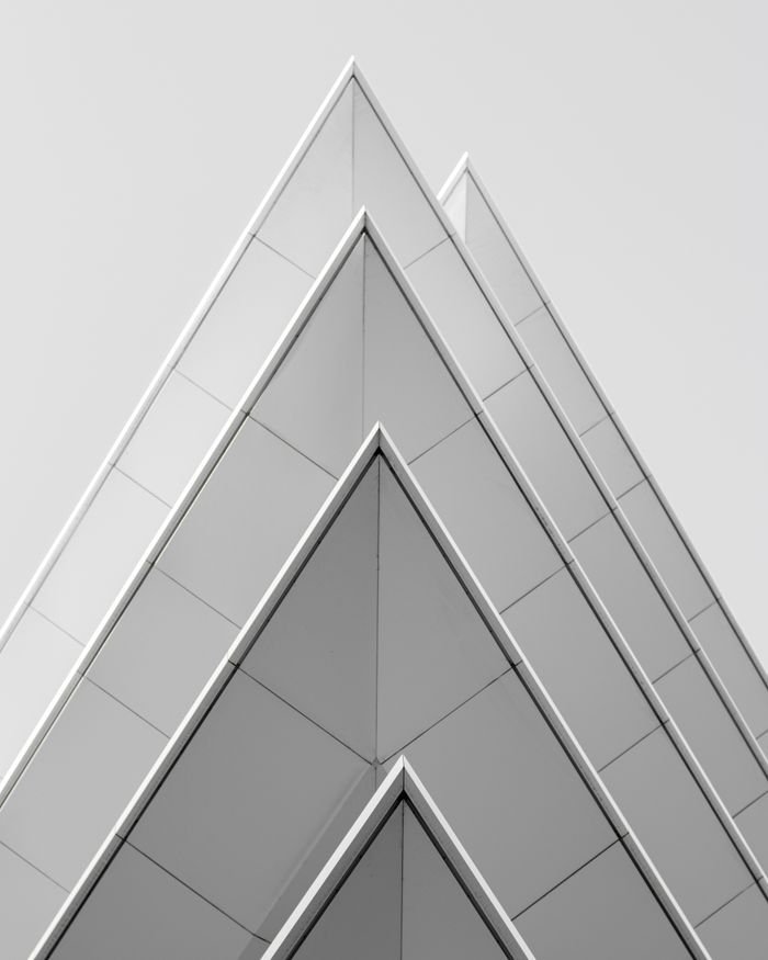 services-05 Futuristic pyramid-shaped building facade in Athens, Greece showcasing modern architectural design.